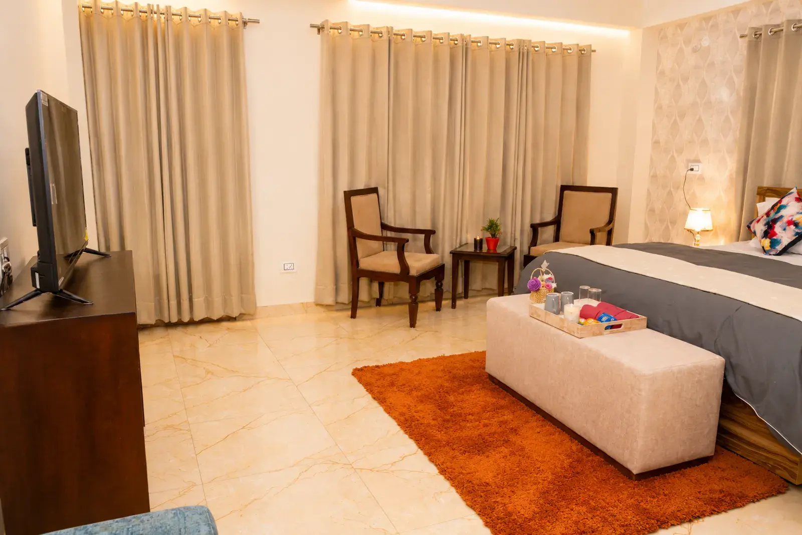 Bedroom 1 with king bed and mountain-facing windows at Noon Villa