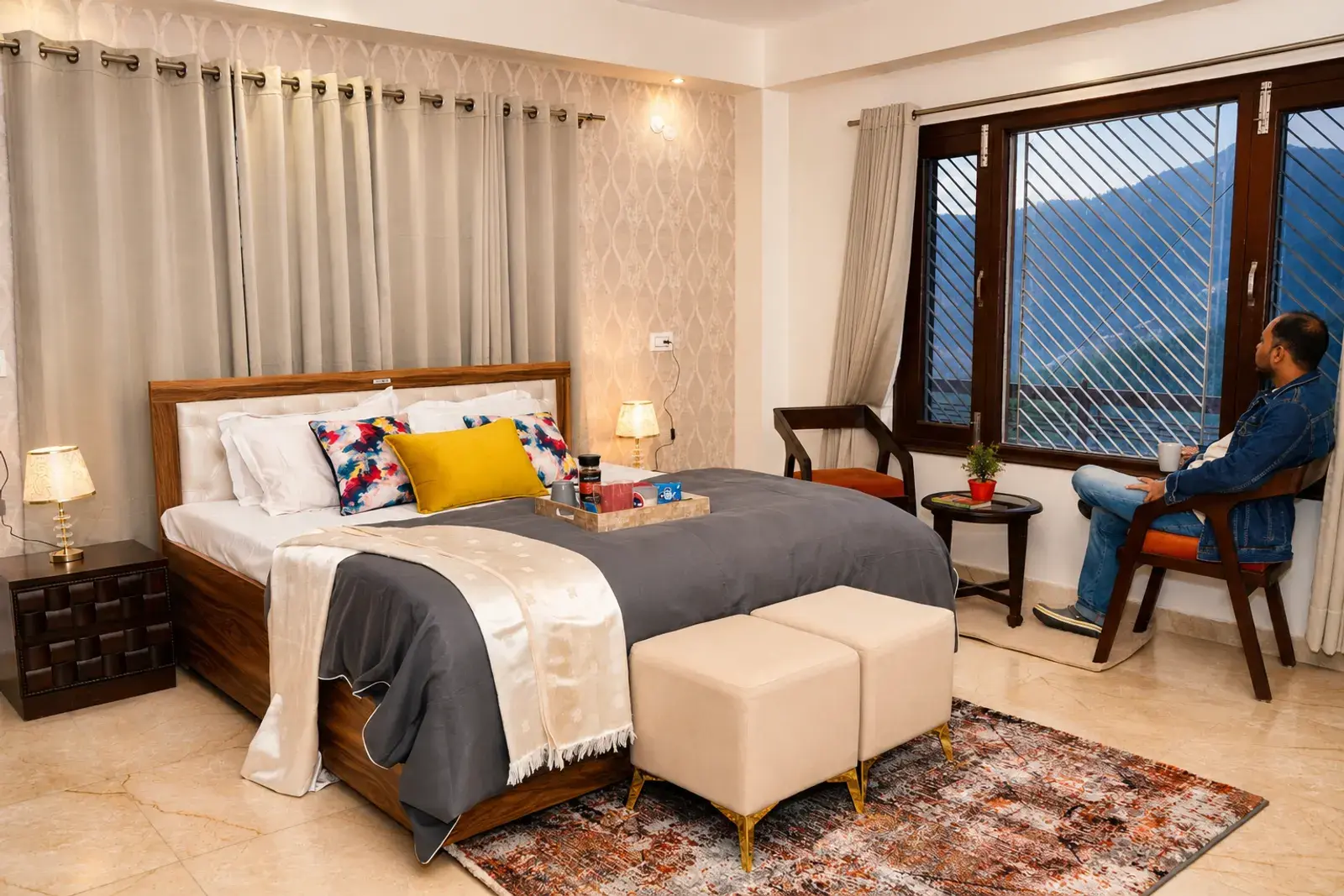 Bedroom with bed and mountain-facing window at Noon Villa
